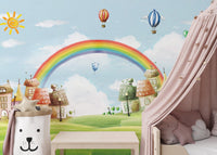 Pastel sky and rainbow wallpaper in a bedroom with a soft pink canopy bed.