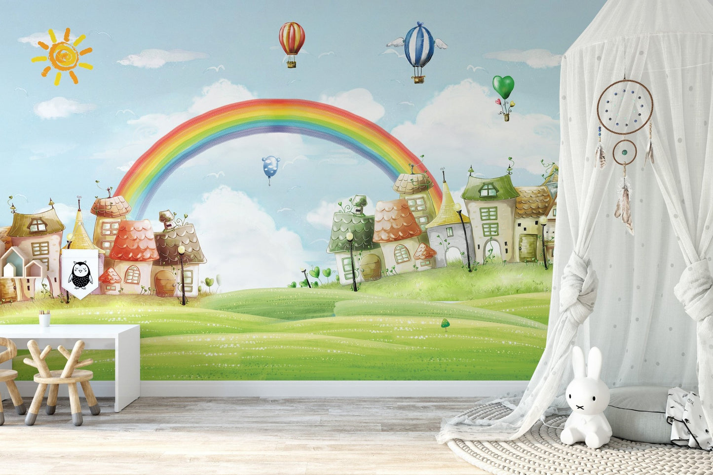 Bright rainbow wallpaper in a nursery featuring a white canopy and toys.