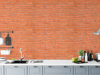 Red brick wallpaper used as a kitchen backsplash behind a white counter.