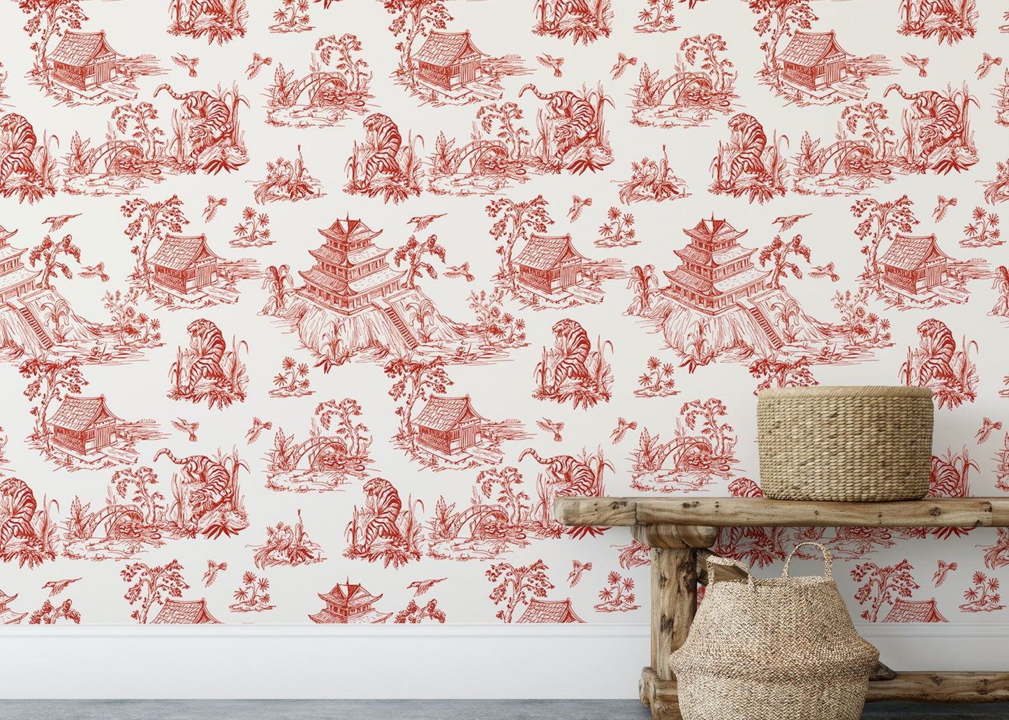 Red patterned wallpaper behind a rustic wooden bench and floral vase.