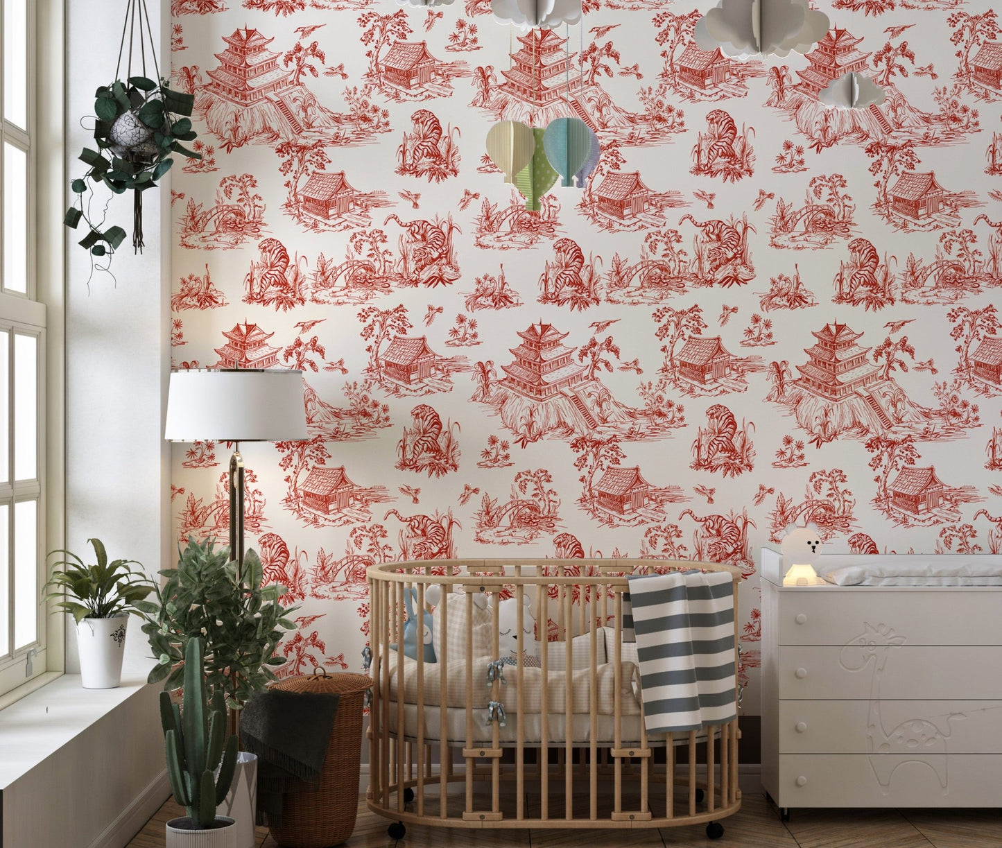 Nursery wallpaper featuring red vintage landscape patterns and a wooden crib.