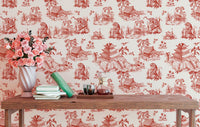 Small reading area featuring red landscape wallpaper and a wooden table.