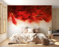 Neutral bed linens paired with a red and gold abstract wall mural.