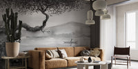Large grey lakeview wall mural in a bright living area with tan leather seating.