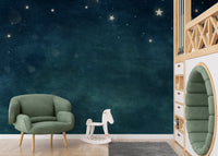 Playroom wall mural with a soft blue nebula and starfield design