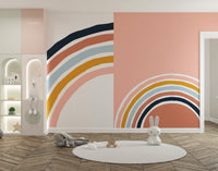 Playroom wall mural with rainbow strips and a circular white rug on wood flooring.