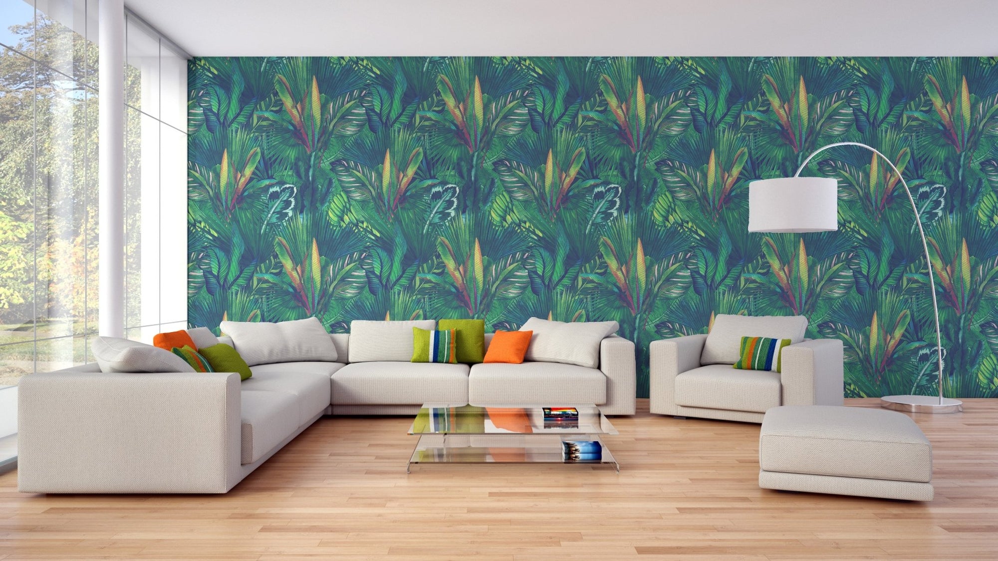 Large white sofa set against green tropical leaf wallpaper for living area.