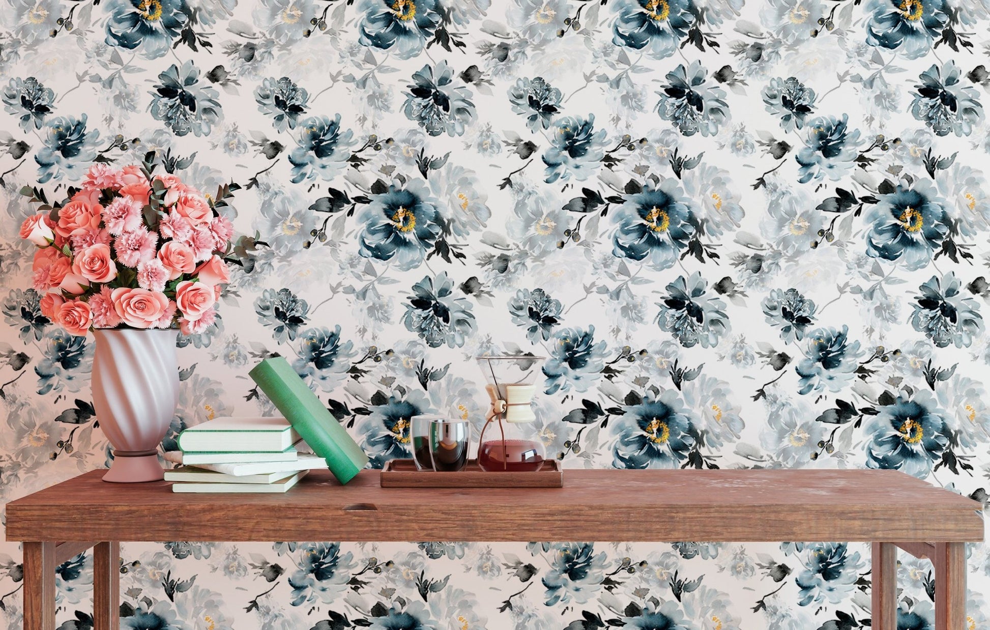 Blue and grey watercolor flower wallpaper behind a wooden console table with decor.