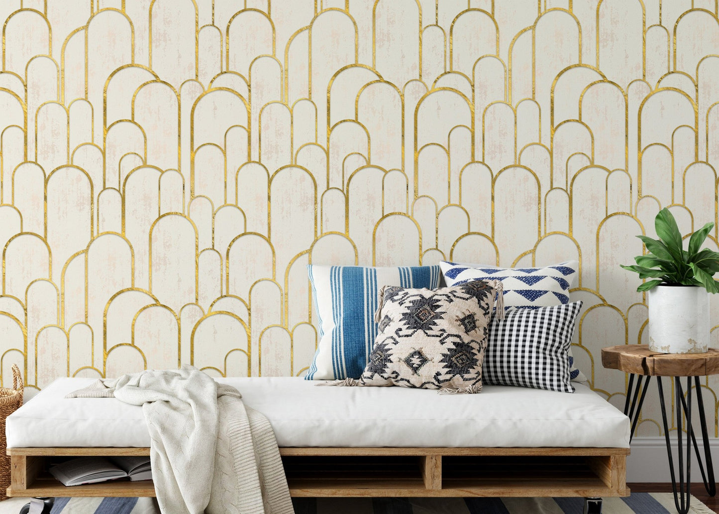 Daybed in sunlit room with gold geometric pattern wallpaper.