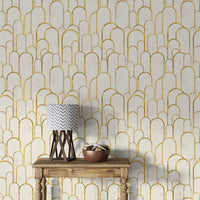 Elegant gold Deco archway design wallpaper behind wooden table.