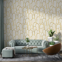 Mint green tufted sofa against gold archway wallpaper in living room.