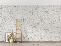 Minimalist white stone wallpaper in an empty room with a wooden ladder.