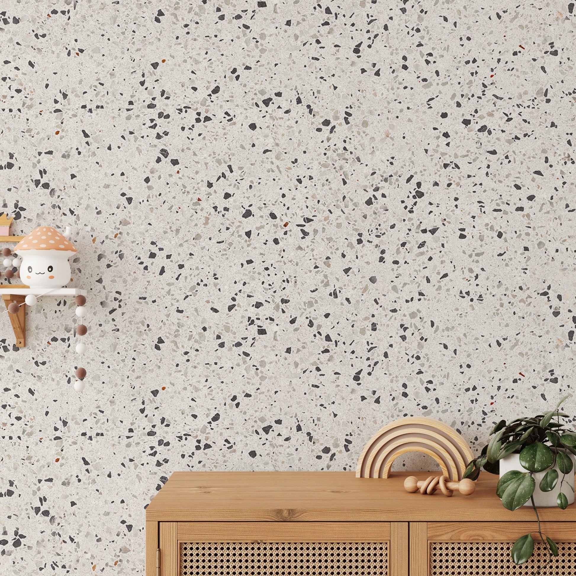 Textured stone wallpaper behind a wooden console unit and hanging decor.