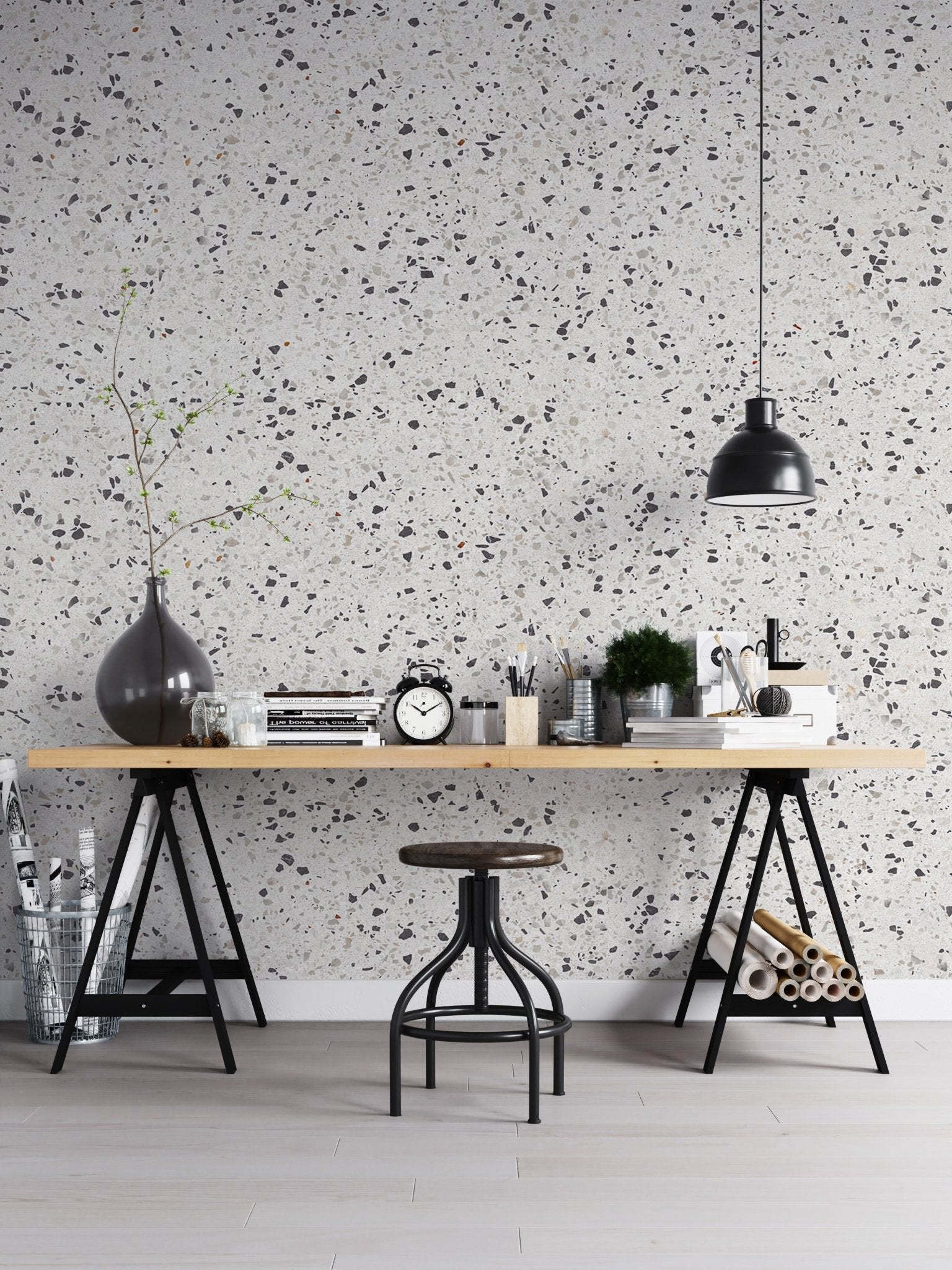 Workspace terrazzo wallpaper with a black desk lamp and industrial stool.
