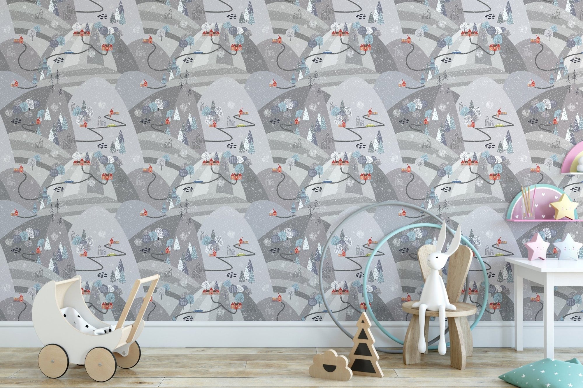 Mountain pattern wallpaper in a kids' nursery with a white toy stroller.