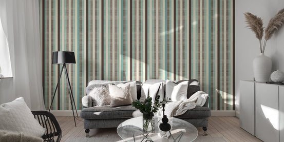 Modern living area featuring striped wallpaper with grey sofa and black lamp.