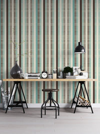Home office setup with vertical stripe wallpaper and industrial metal desk.