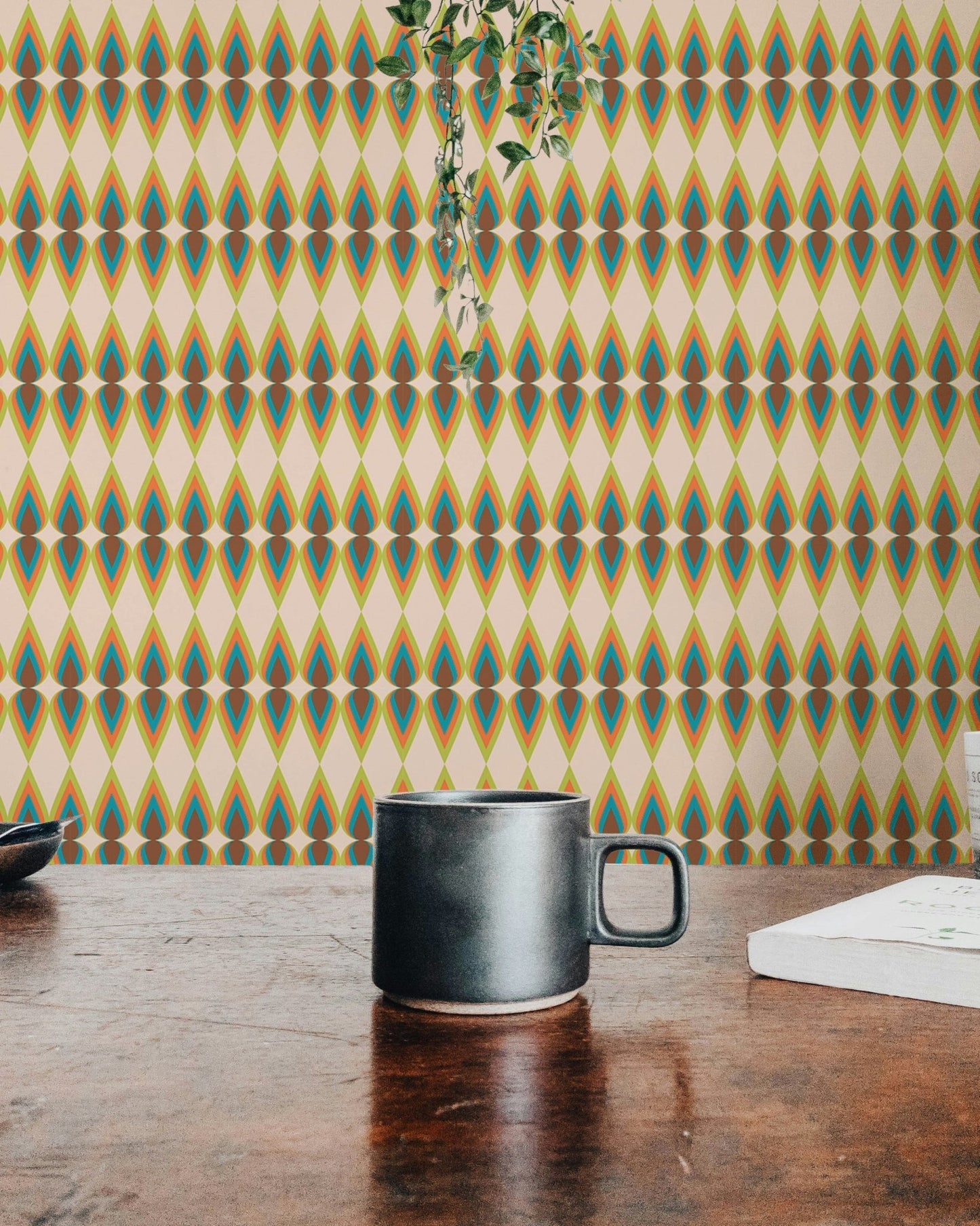 Morning light on a striped wall mural in a room with a hanging plant.