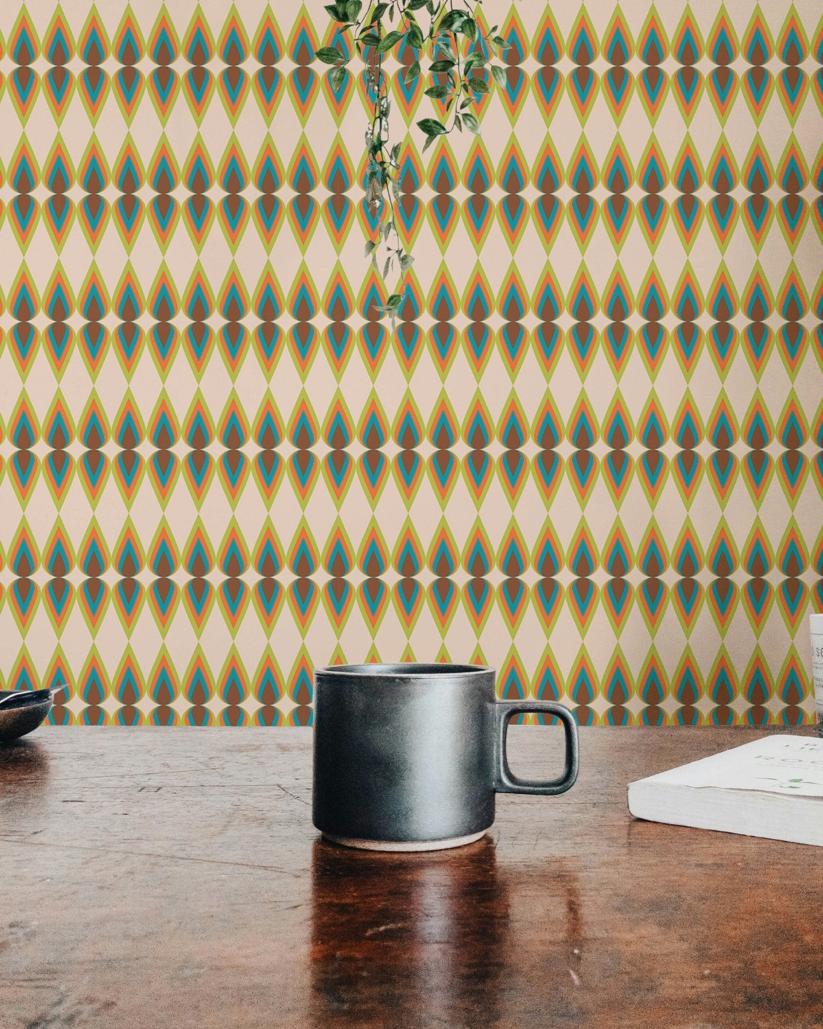 Morning light on a striped wall mural in a room with a hanging plant.