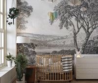 Vintage river valley wall mural installed in a nursery with a wooden crib.