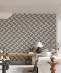 Geometric wavy wallpaper in a living area with a lamp and side table.