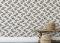 Grey repeating wave wallpaper behind a wooden bench and woven basket.
