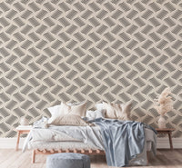 Grey and white wavy pattern wallpaper behind a living room sofa.
