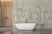 White freestanding bathtub against green botanical wall mural in a modern bathroom.