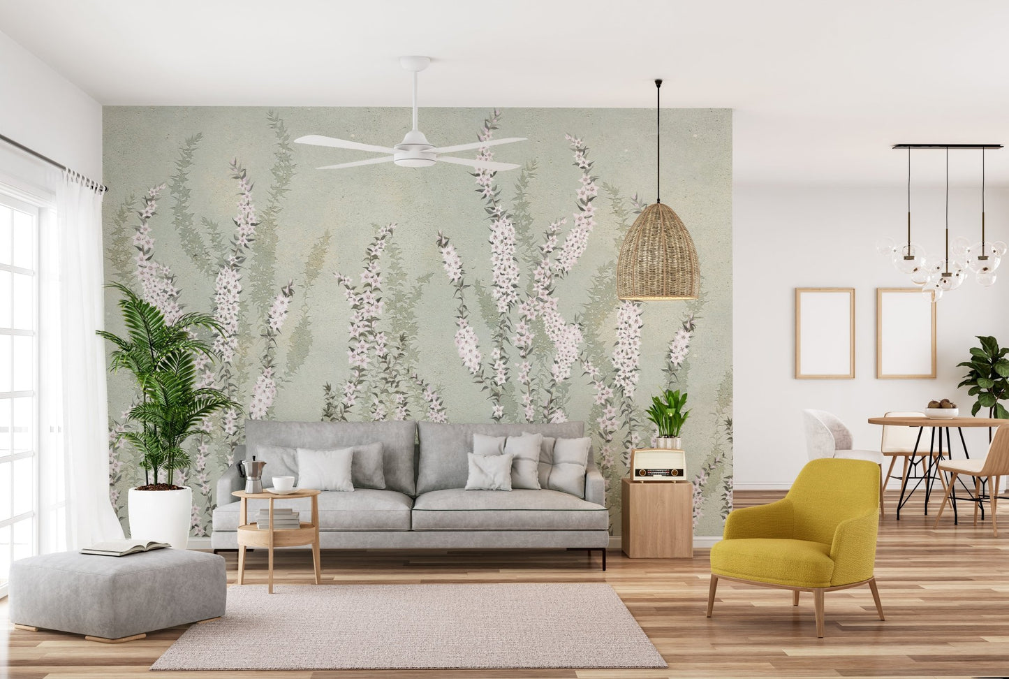 Modern living room featuring green floral wall mural behind a grey fabric sofa.