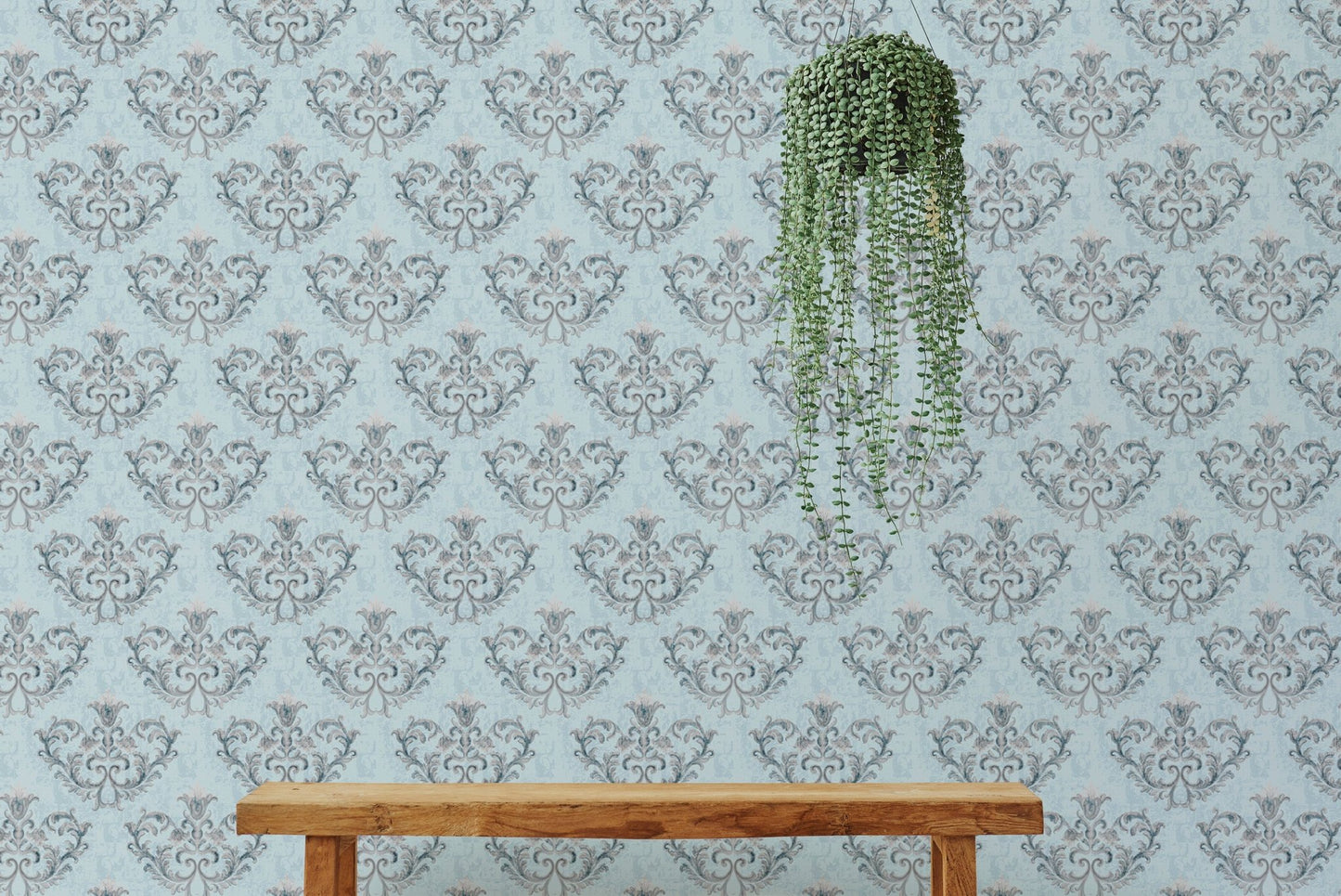 Textured floral wallpaper behind a wooden bench with hanging plants.
