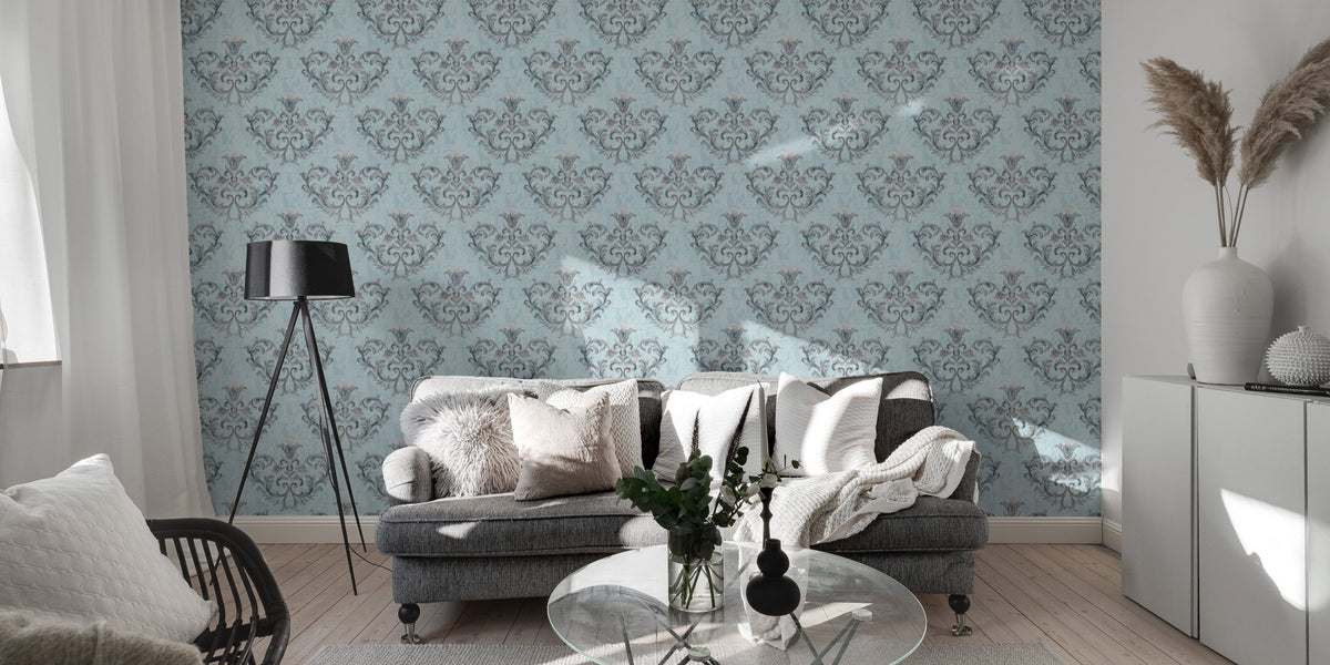Blue repeat pattern wallpaper in a living space with a grey rug and glass table.