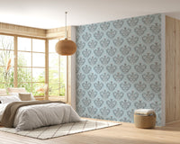 Floral damask wallpaper in a master bedroom with a large window and sunlit bed.