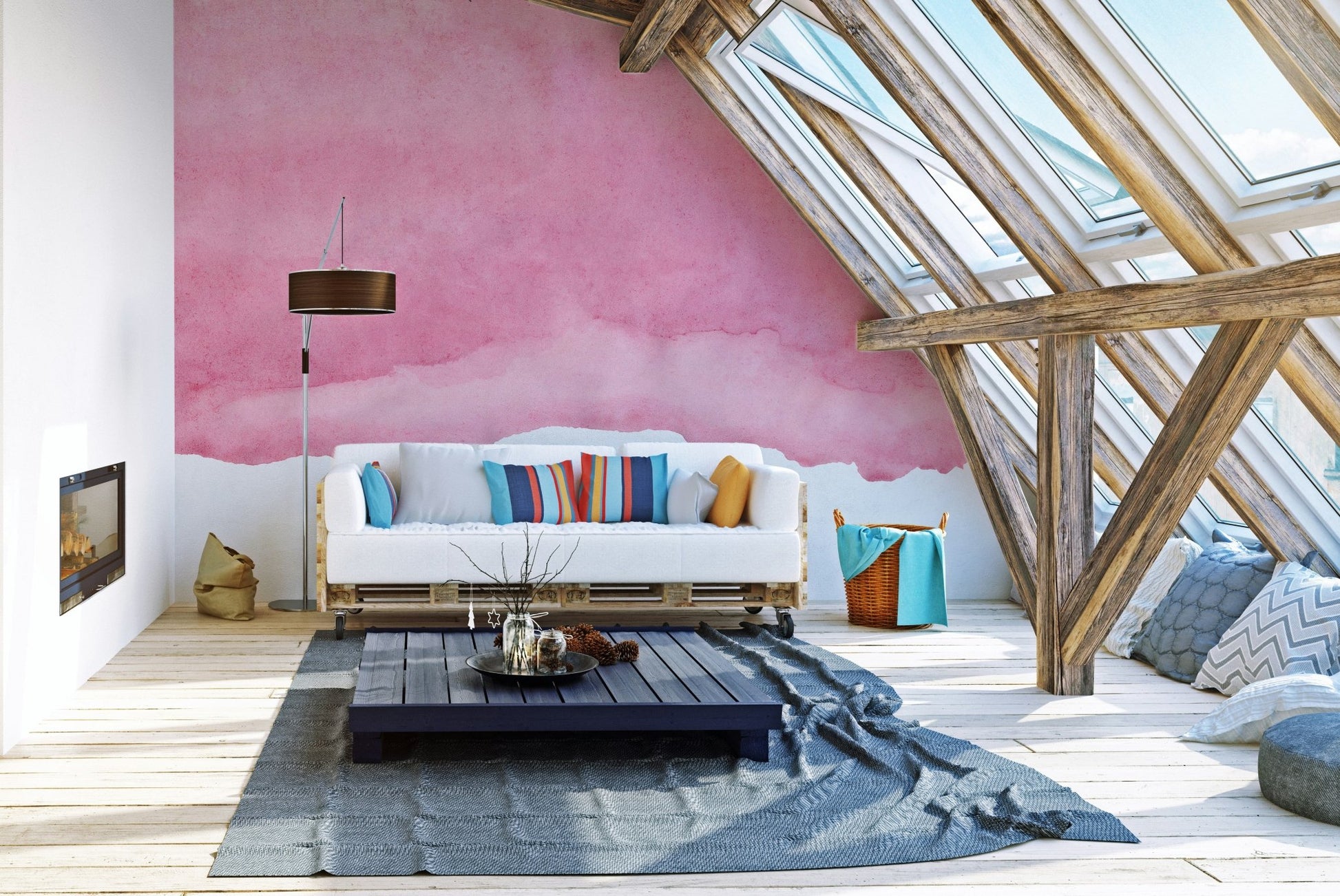 Shaded pink watercolor wall mural in a loft apartment with a white sofa.