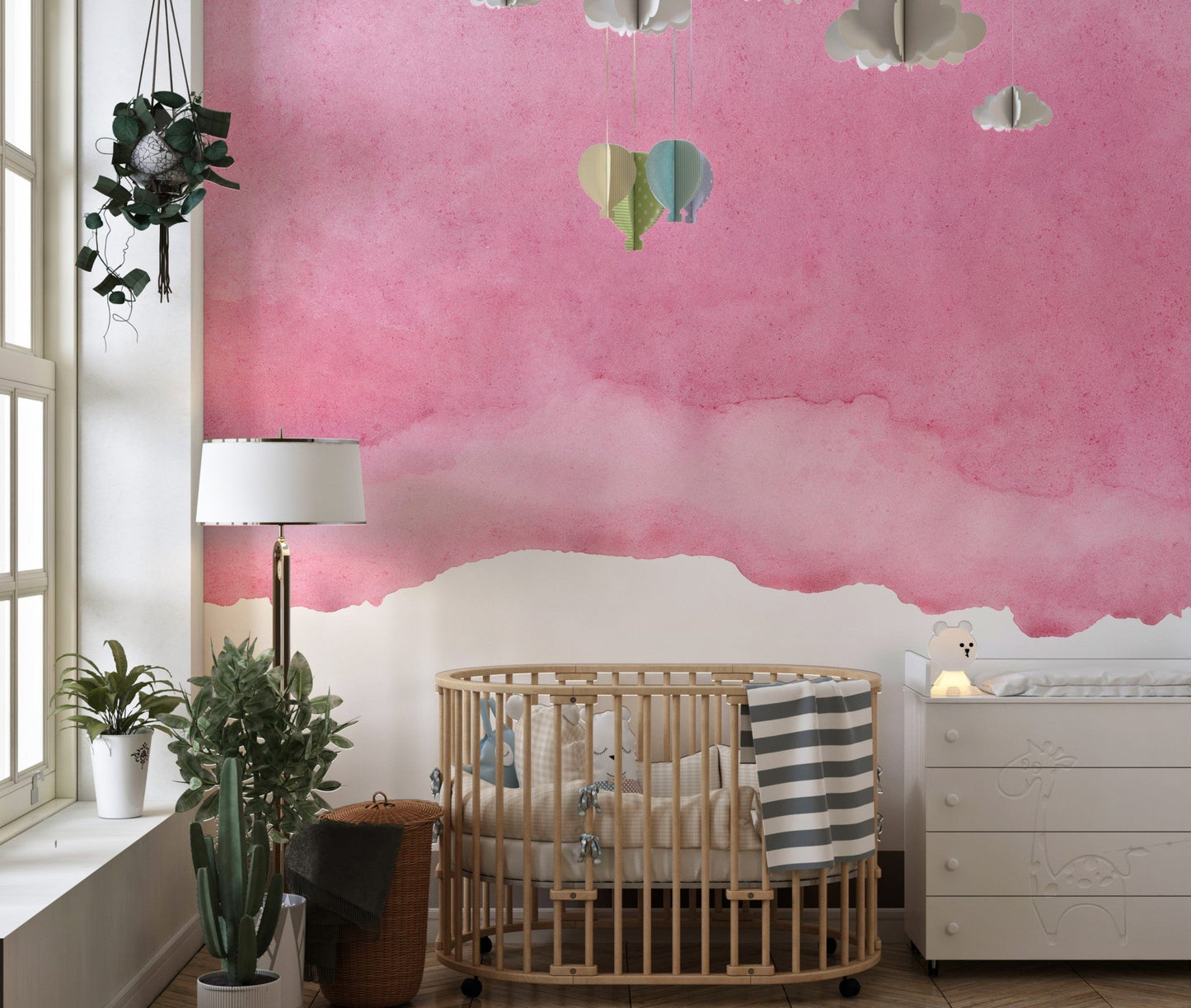 Romantic Watercolor Pink Shades Wall Mural in a nursery with a wooden crib.
