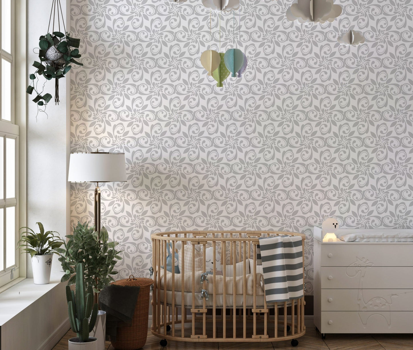 Patterned floral wallpaper in nursery with wood crib and green accents.