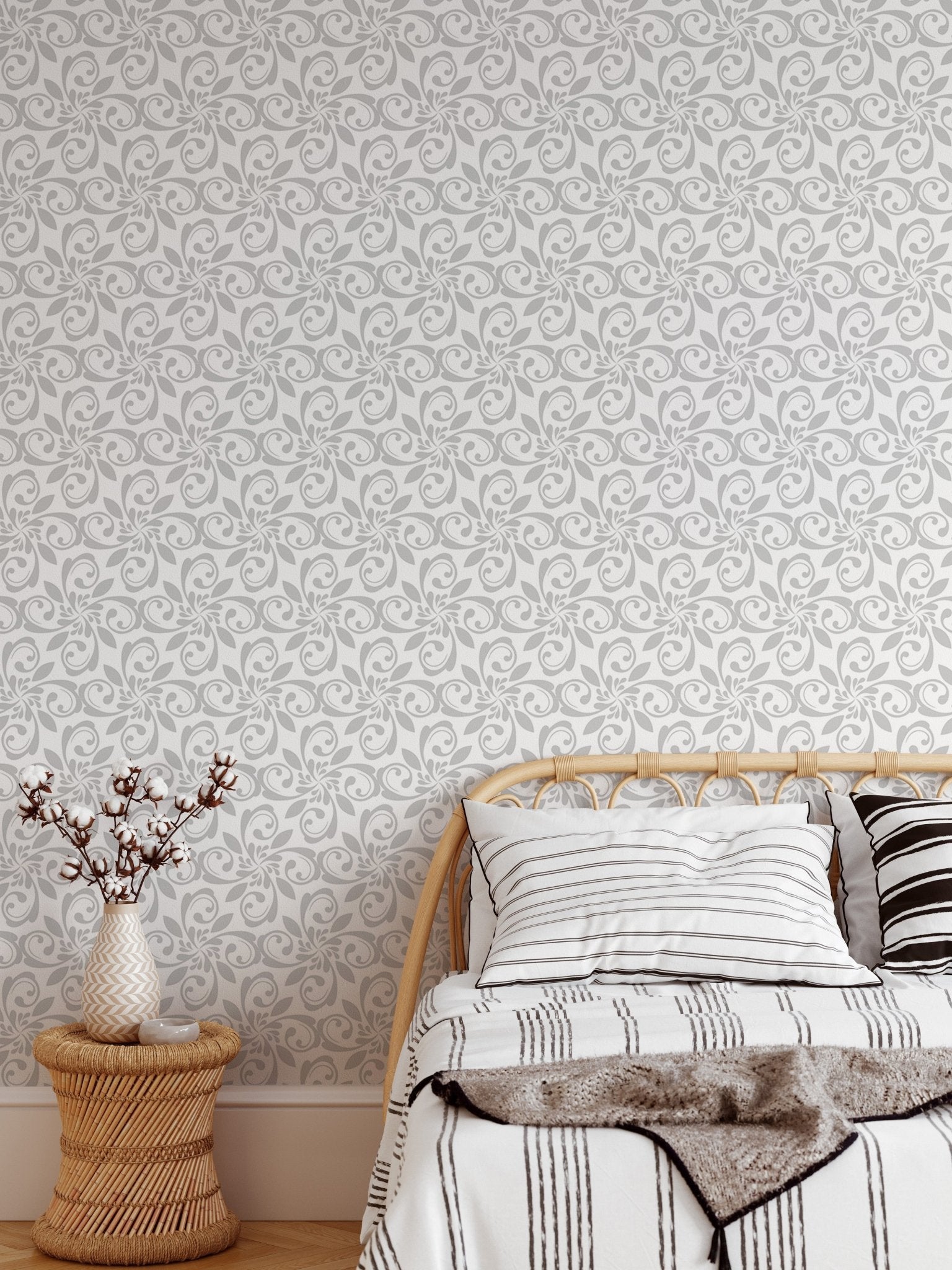 Floral ornament wallpaper in bedroom with wood bed frame and white pillows.