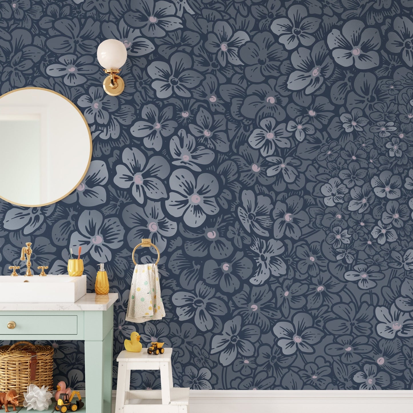 Floral wall mural in a bathroom next to a mint green vanity and round mirror.
