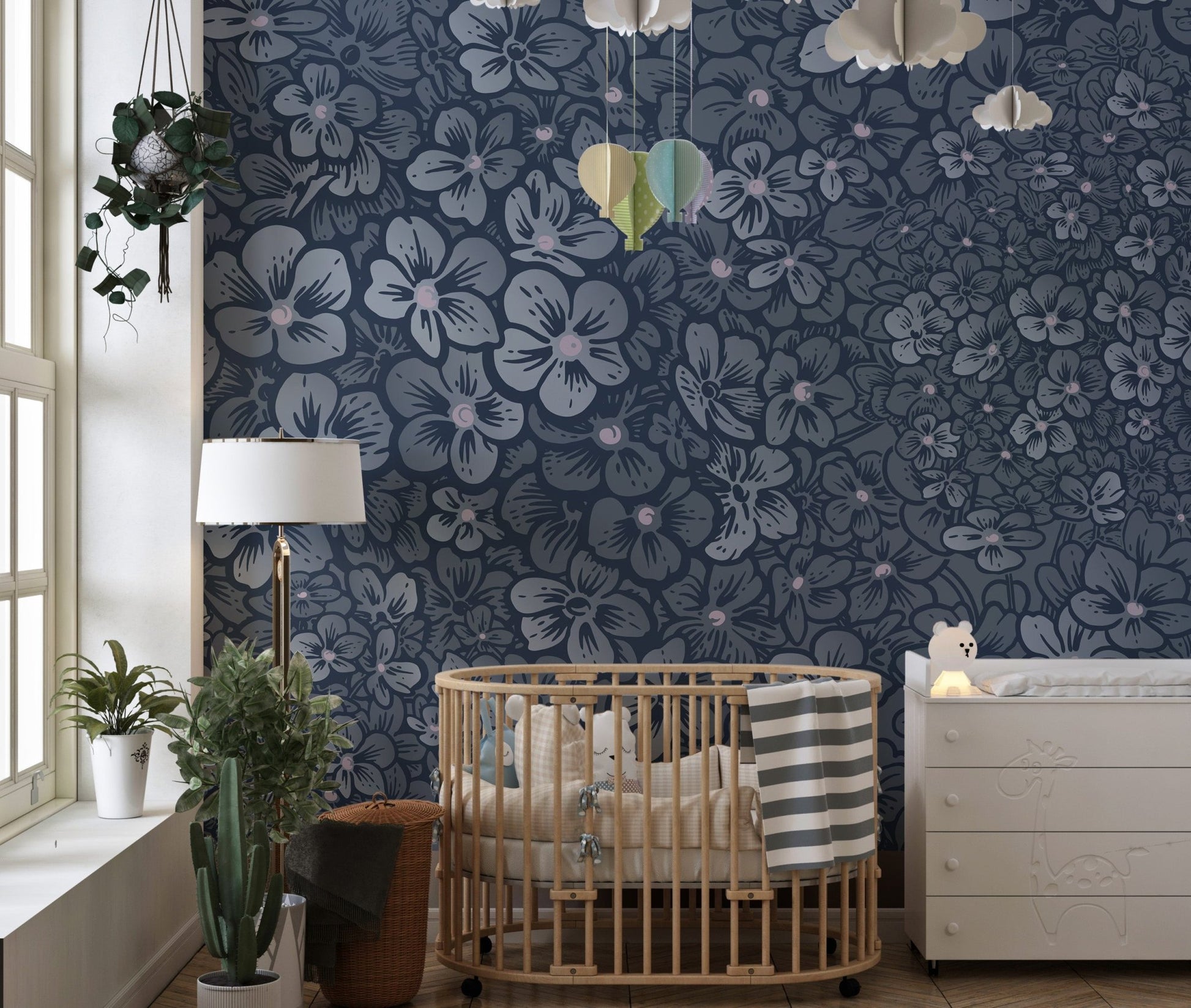 Navy floral wall mural in a nursery with a wooden crib and neutral decor.