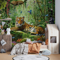 Realistic safari wall mural in a child's bedroom with a floor bed and pillows.