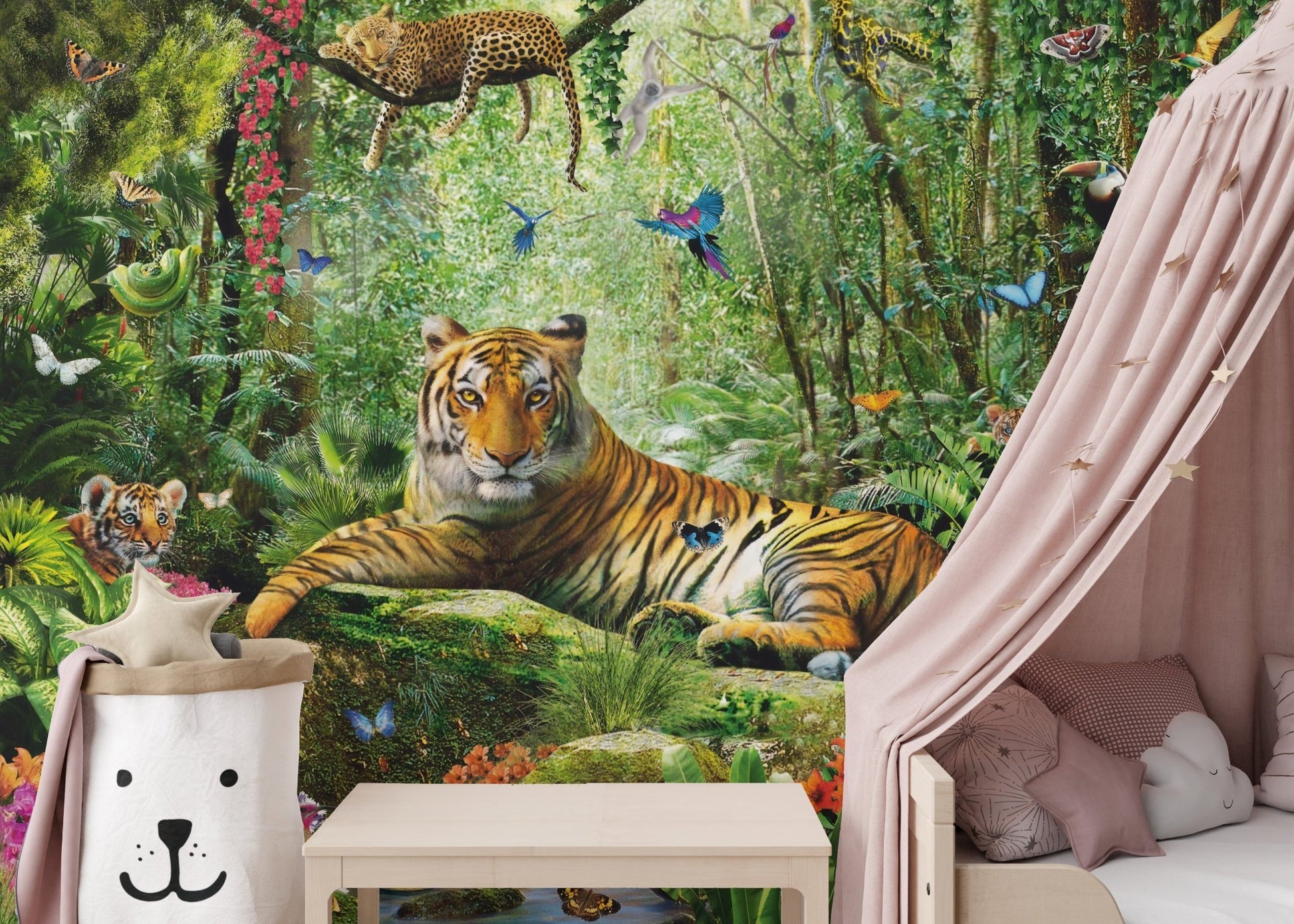 Green safari wall mural behind a pink canopy and wooden bench.