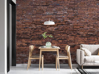 Modern dining room featuring a dark brickwork wallpaper mural and wooden furniture.