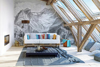 Monochrome alpine mountain wall mural in a spacious living room with a blue rug.