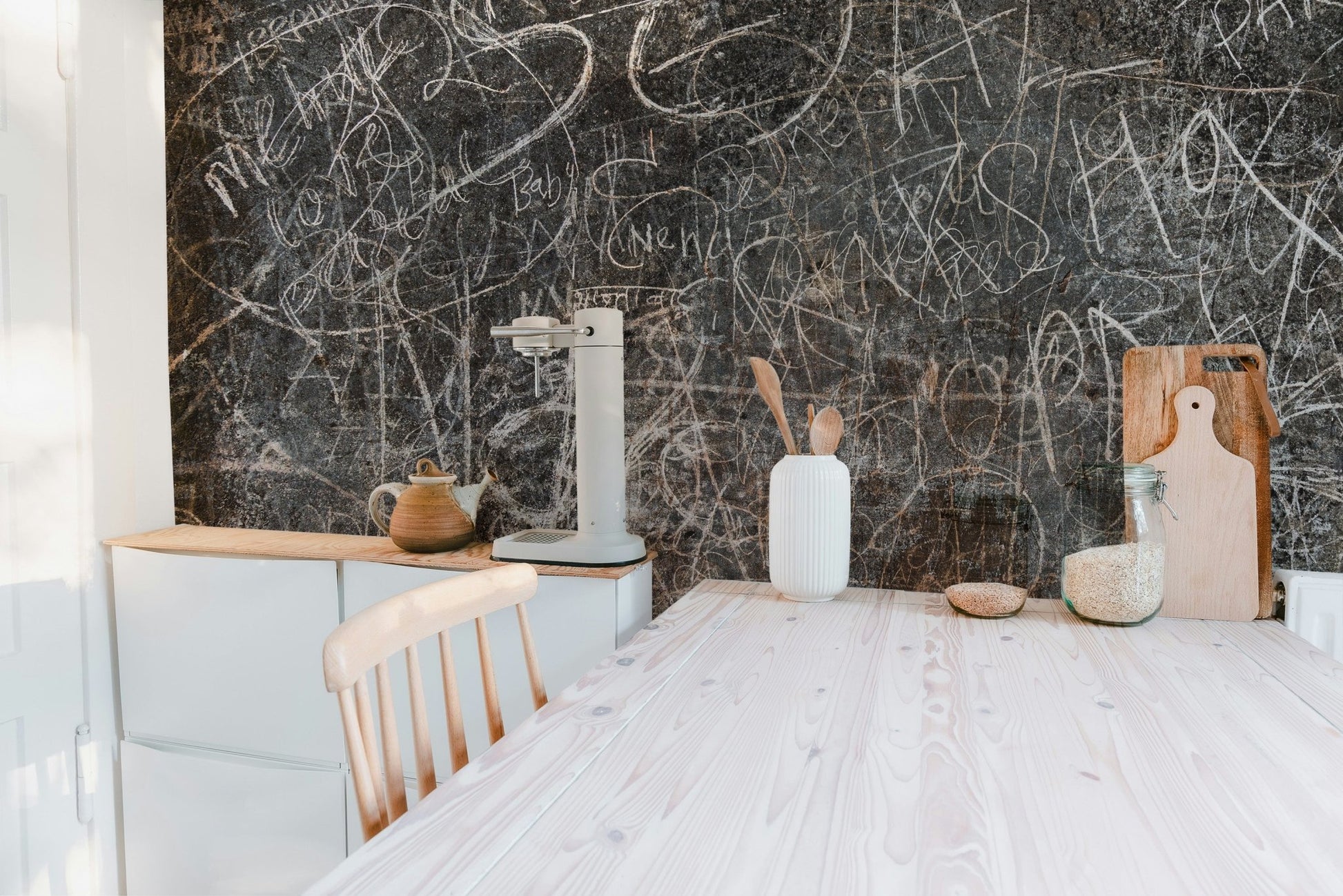 Aged concrete look with abstract script wall mural for kitchen interior.