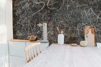 Aged concrete look with abstract script wall mural for kitchen interior.