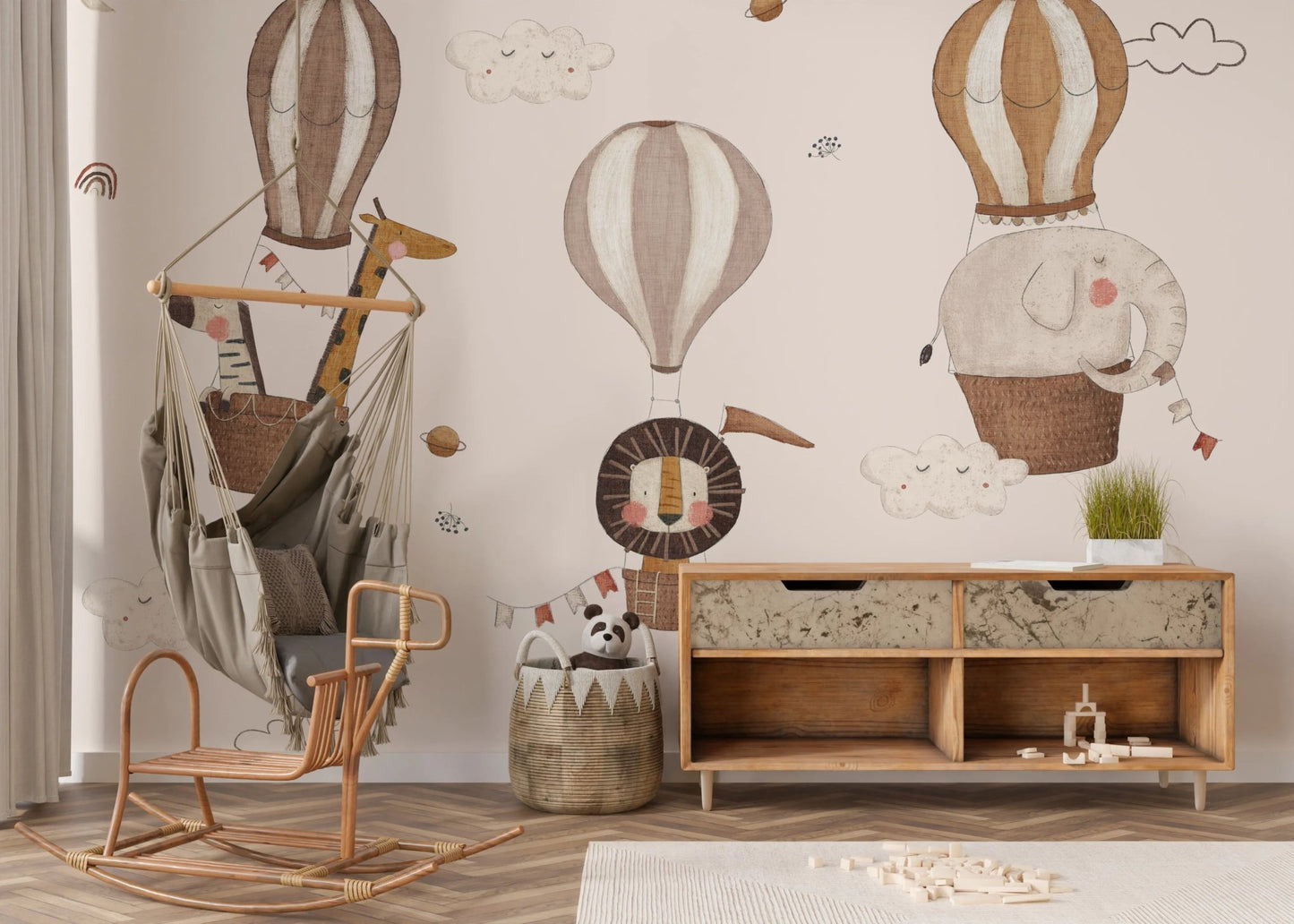 Artistic wall mural featuring a giraffe in a blue patterned balloon basket.
