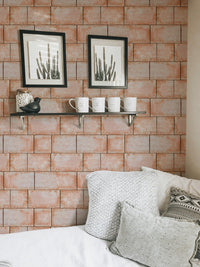 Sandstone blocks wallpaper in a light filled studio apartment.