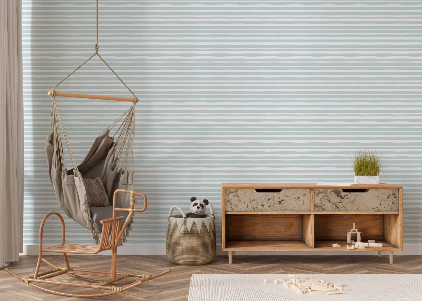Living space featuring a wooden rocking chair against sea green striped wallpaper.