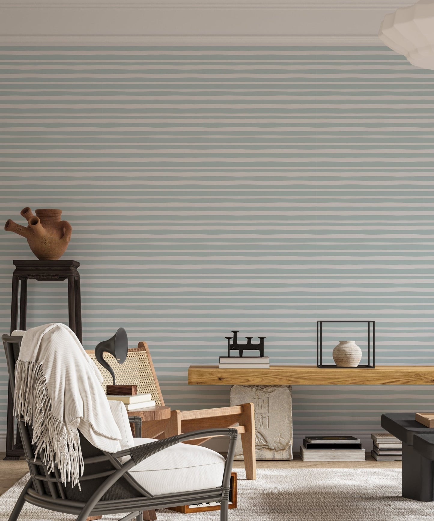 Study room featuring sea green wallpaper with a dark lounge chair and desk.