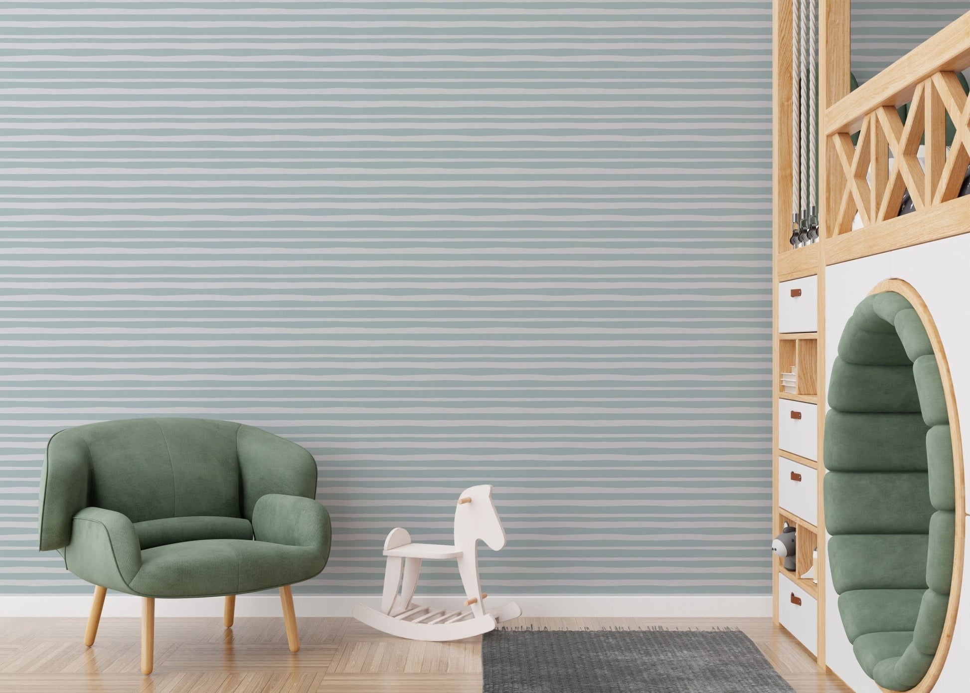 Kids play area with sea green linear stripe wallpaper and a green armchair.