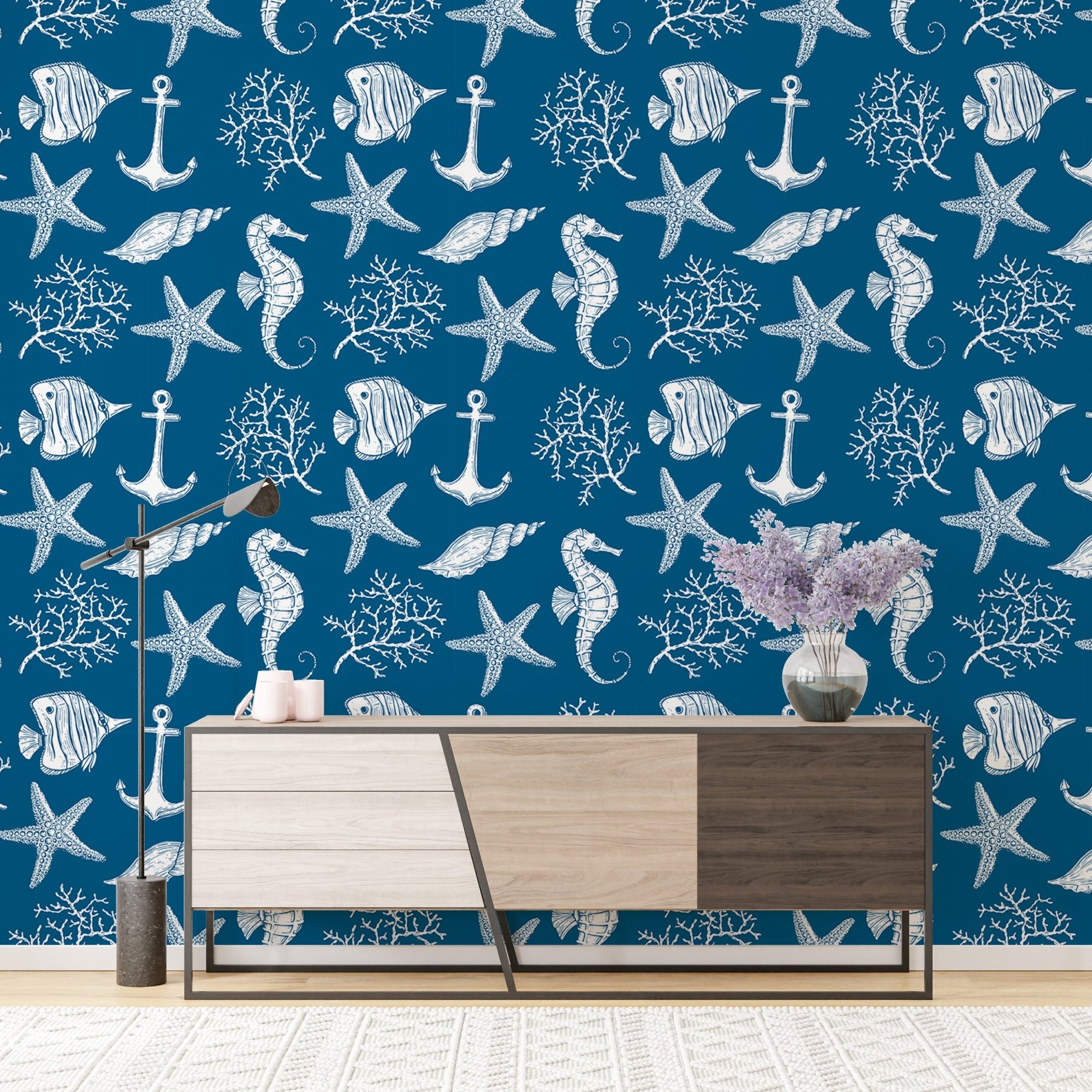 Sea style underwater creatures fish blue color wallpaper behind a modern wood sideboard.